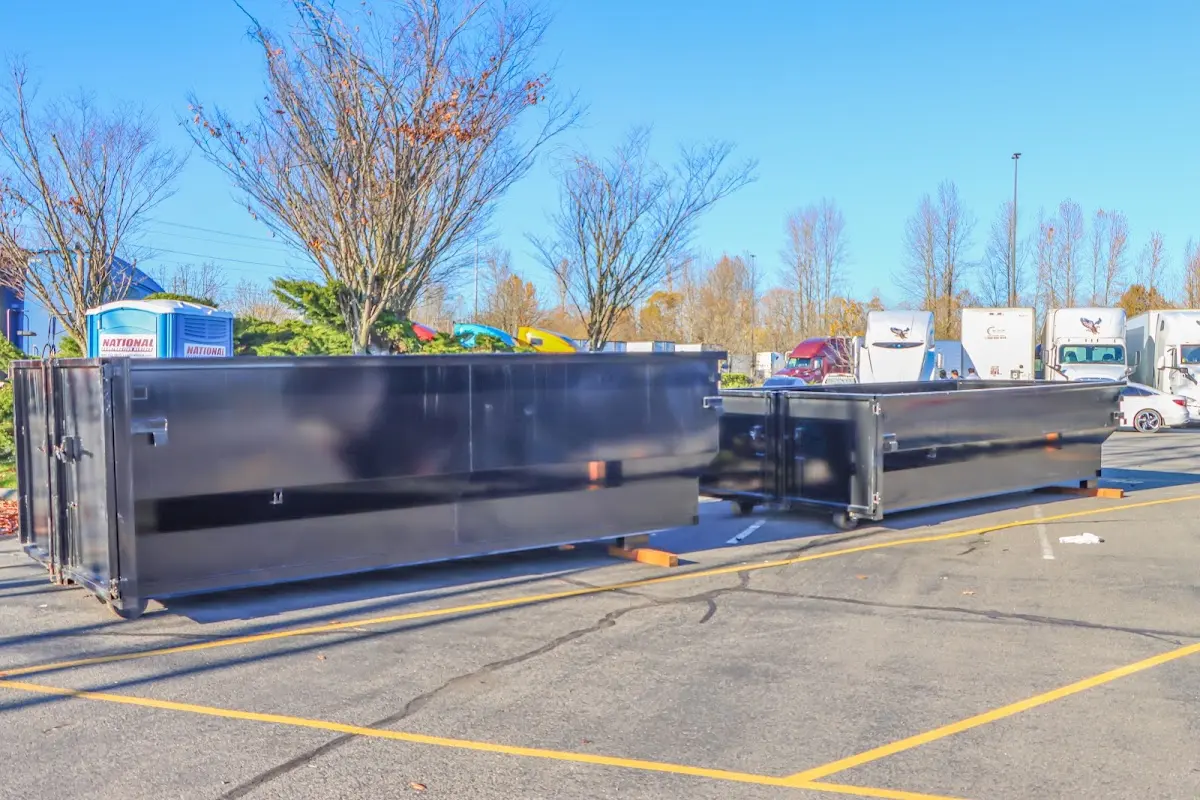 Professional dumpster rental service with roll-off container on residential driveway in Fuquay
